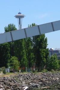 [Photo: Seattle Tower, covered conveyor belt, trees, shore]