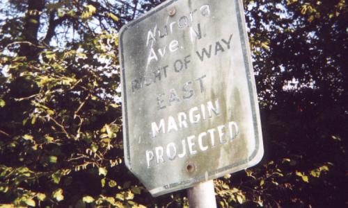 [Photo: street sign 'Aurora Ave. N. right of way east margin projected']