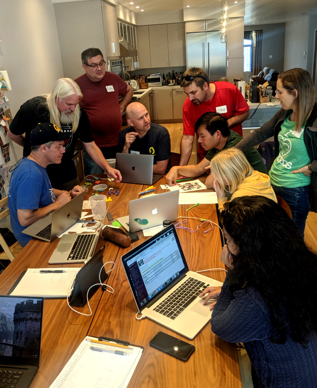 [Picture: nerds gathered around long table]