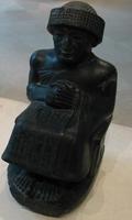 [Photo: Sumerian statue]