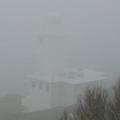 [Photo: lighthouse through fog]