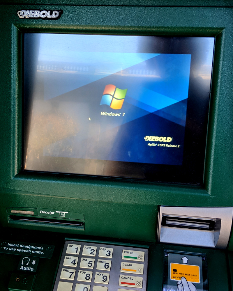 photo of an ATM showing a frozen Windows 7 boot screen