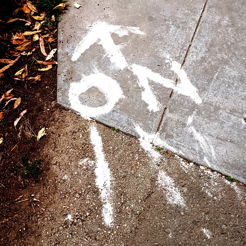 photo: chalk marks on ground: phrase 'on in' with an arrow