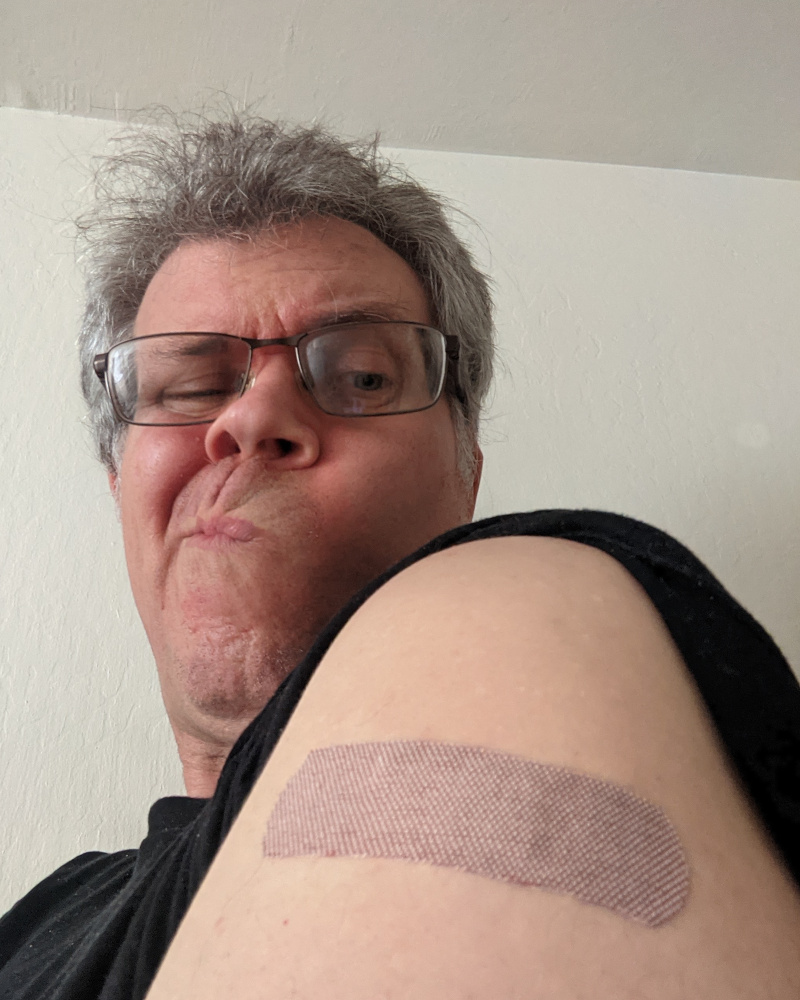 selfie with a bandaid-festooned shoulder in the foreground