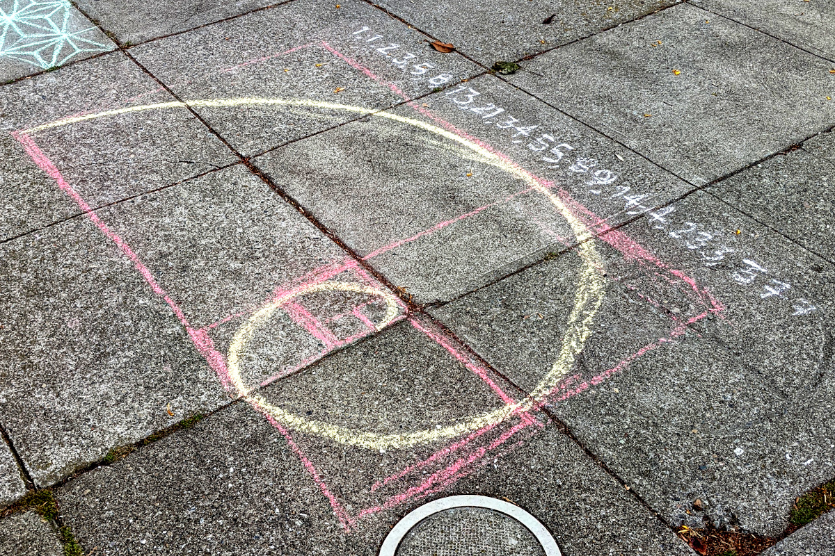 Sidewalk chalk art with the first several terms of the Virahanka-Fibonacci sequence and a gold nautilus