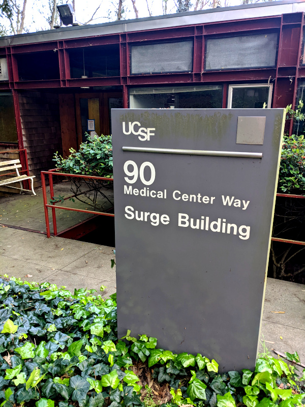 Sign in front of a building. The sign proclaims: Surge Building