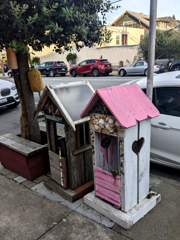 sidewalk decoration in the form of two miniature beach shacks