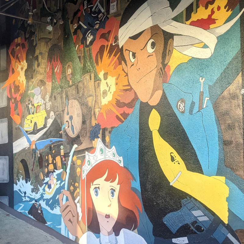 "Caglibistro" mural featuring Castle Cagliostro-inspired art with a sprinkling of Sushi Bistro logos