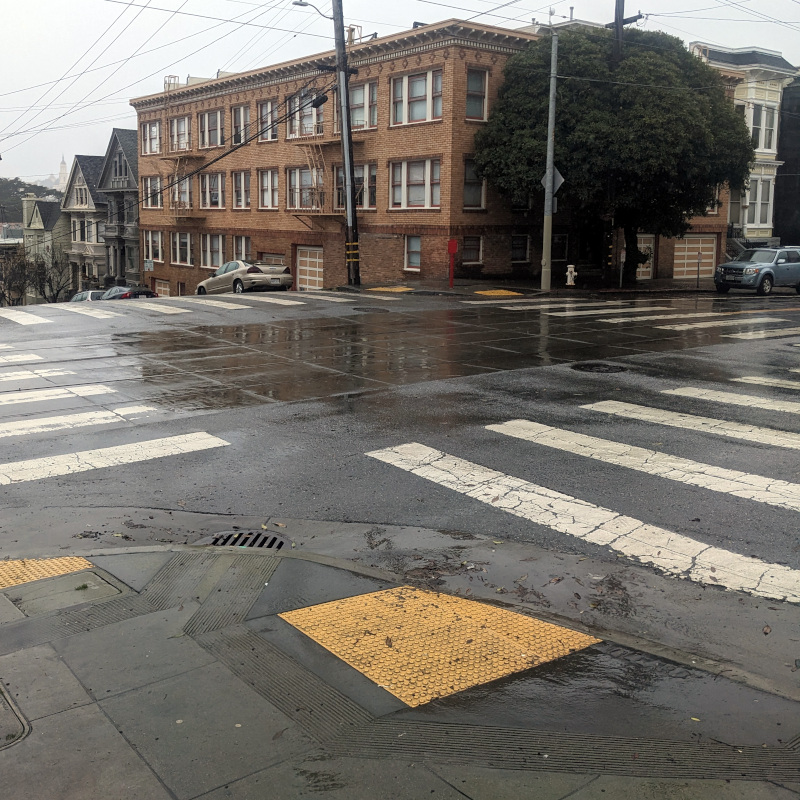[photo of a rain-soaked intersection]