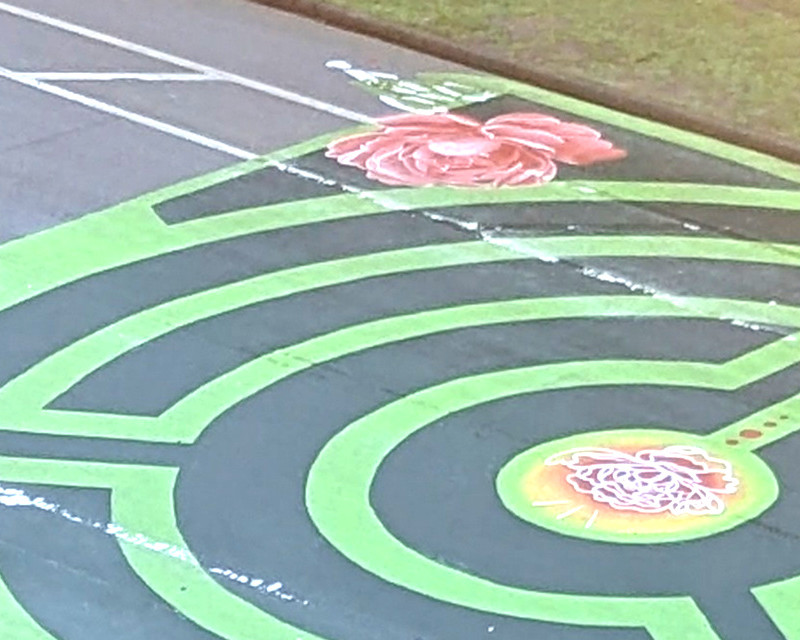 fragment of a labyrinth with some white bike lane paint showing through