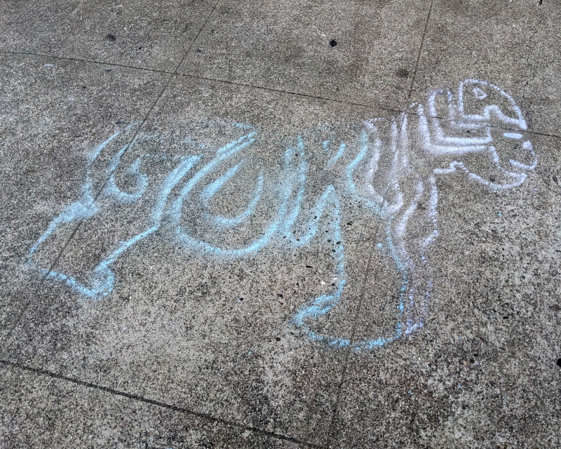 sidewalk chalk art: a gorilla drawn using the letters in the word gorilla