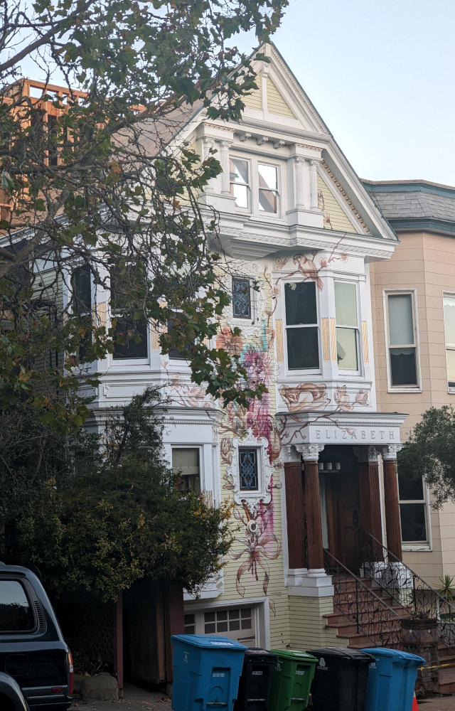 old (Edwardian?) house with a fancy mural painted on the front: plants, animals and a big all-caps "Elizabeth"