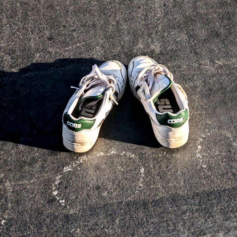 pair of Converse shoes, branded "Cons"