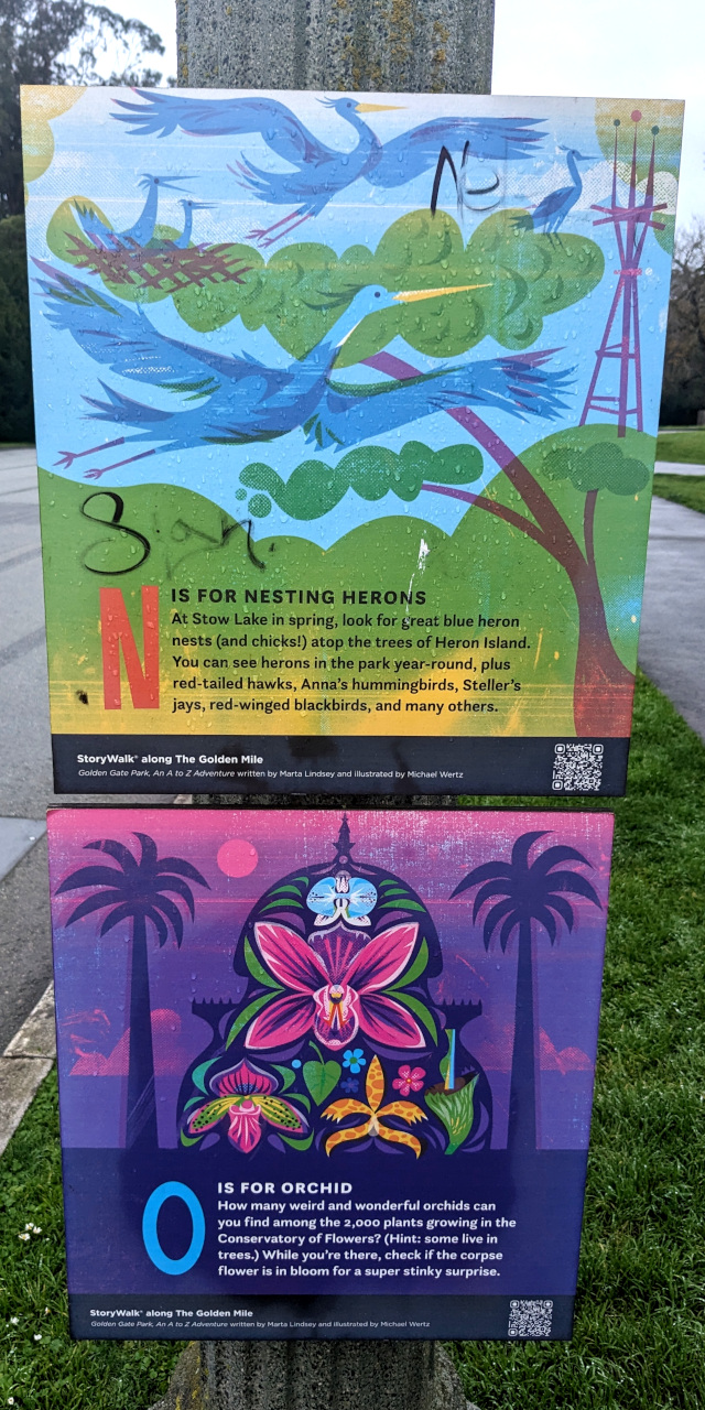 two signs with some pretty art letting you know that N is for Nesting herons and O is for Orchids