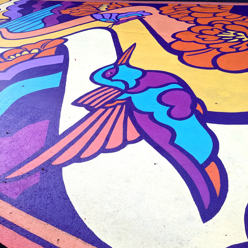 detail of a hummingbird from a street mural