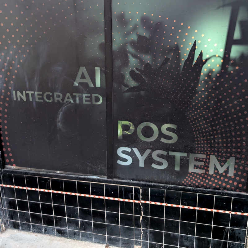 storefront window painted to advertise: AI integrated PoS system