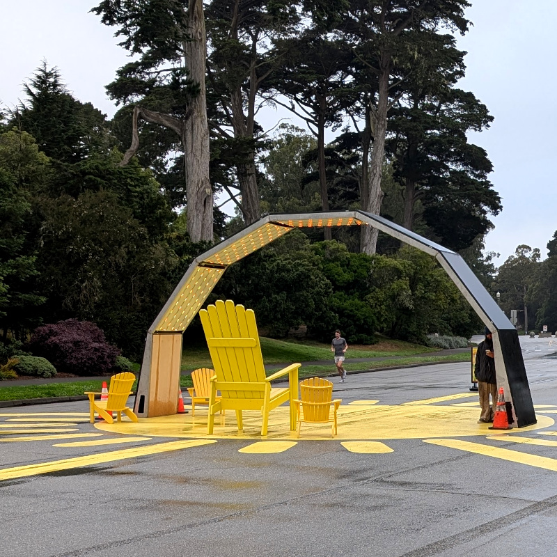 light-up arch on road in park. the road has a yellow sunburst painted on it.