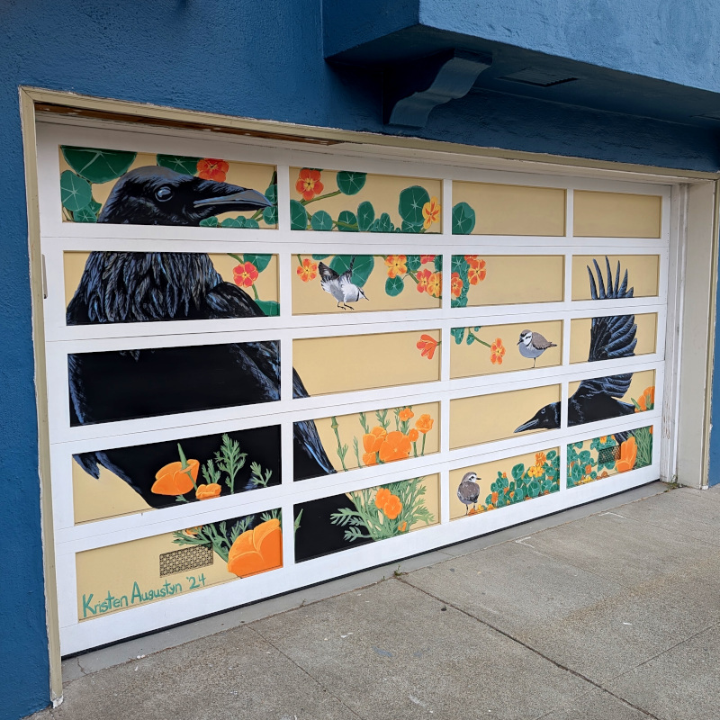 garage door painted as a mural of birds and plants. There are ravens (or crows?) and other birds, uh, shorebirds? Sorry I don't know my birds. The plants are California golden poppies and, uh, nasturtium? Sorry, I don't know my plants, either.