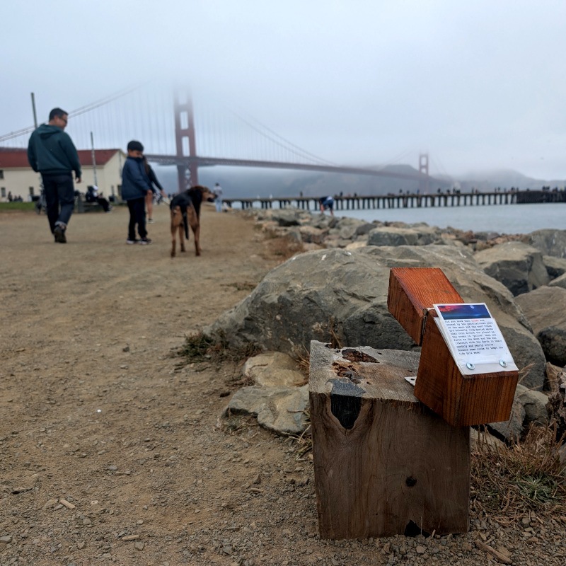 little wooden box atop a stumpy wooden block alongside a path by the old Torpedo Pier. also a cool dog and some bridge