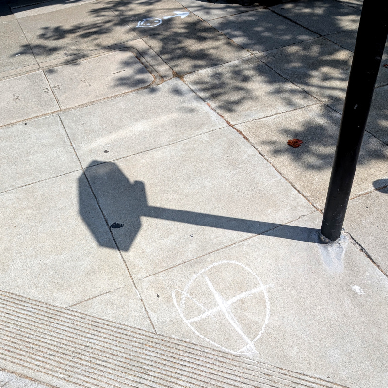 chalk ⨂ on a sidewalk