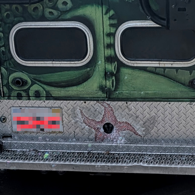 bumper of an art-car ambulance. There's a starfish painted; it has a hole in the middle. if you squint, you can kinda see that there are soap bubbles emerging from the hole