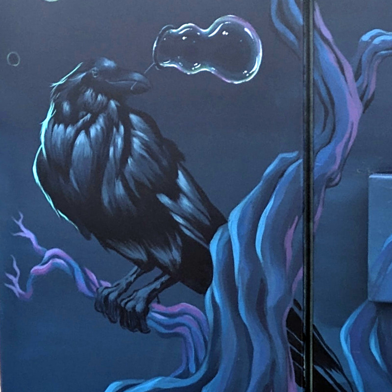 utility box painted with a spooky tree in dark blues and bright purples