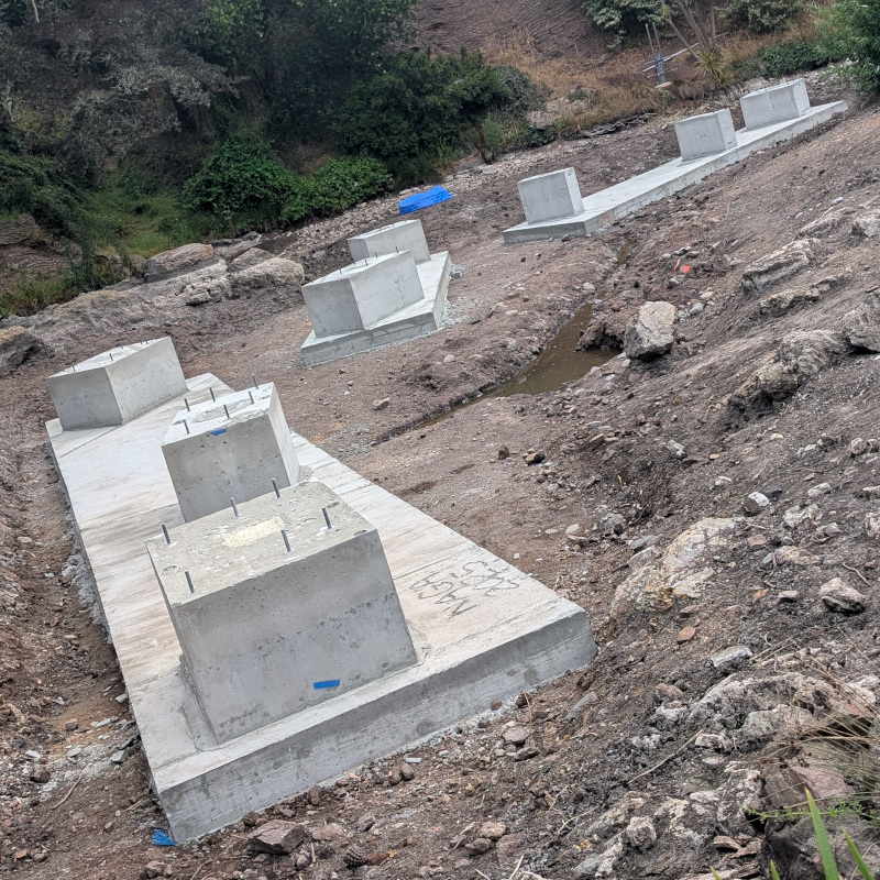 cement supports in a drained pond. Individual parts of the supports are rectilinear solids; but they're arranged at angles to each other