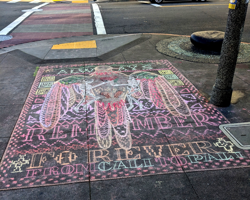 sidewalk chalk art depicting dove, skeletons. text says Always remember / Forever from Cali to Pali