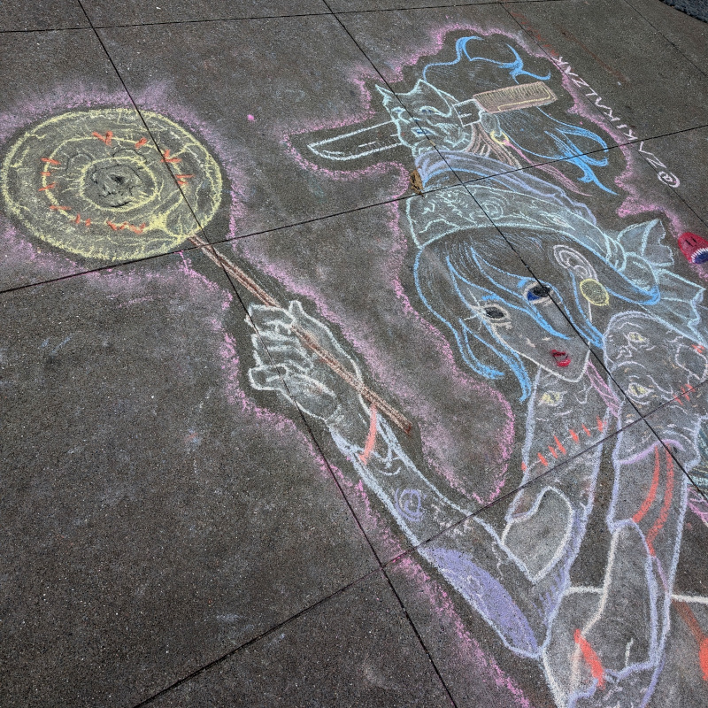 sidewalk chalk art. zooming in on top left of the skater. she wields a lollipop overlaid with a faint mouse skull. her arms are perhaps tattooed or are perhaps Frankenstein-ish combinations of things.