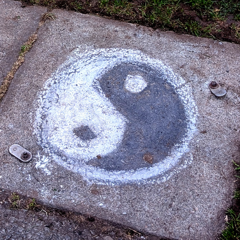 sidewalk chalk art: yin-yang symbol