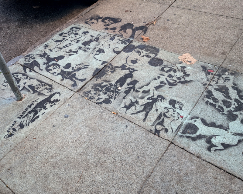 sidewalk stencil graffiti. Lots of human and animal figures. The humans tend to wear makeup: lipstick, mascara. there are some inverse-drawings, in which the figure is the absence of paint, a technique well-suited to stencils