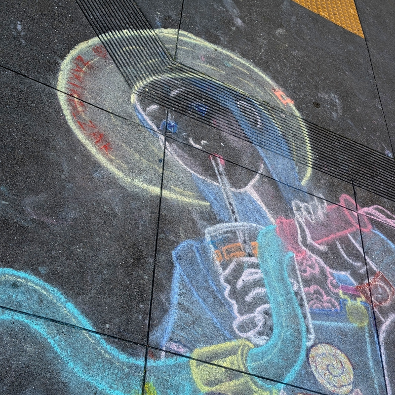 zooming in on the figure's head. is that a space helmet? a halo? hmm, maybe a sunhat?