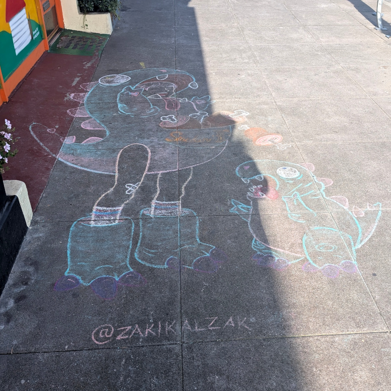 sidewalk with chalk art: a smiling lady in a kaiju suit tosses Flintstones-style meat bits to a cute baby dinosaur