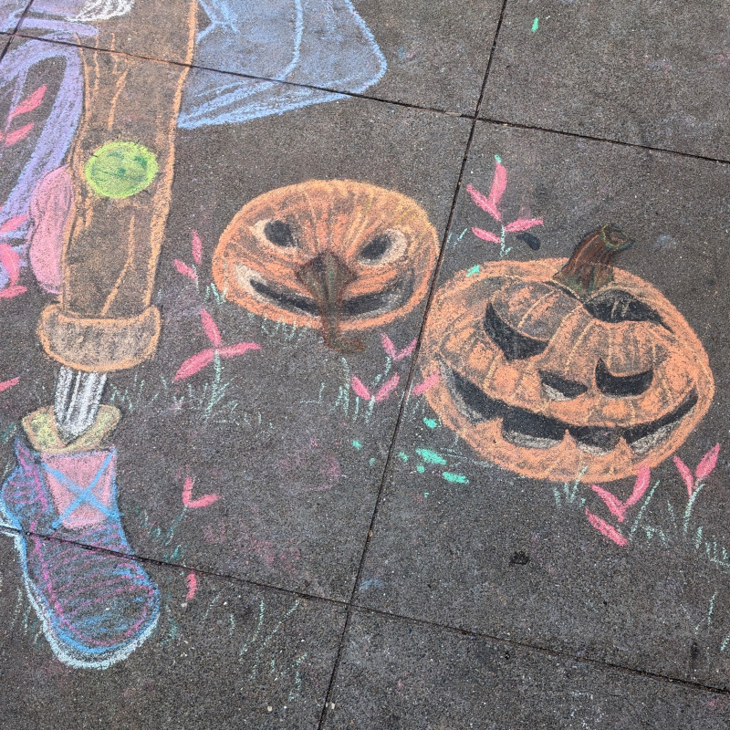 sidewalk chalk art: this pair of jolly jack-o-lanterns wish you a gourd evening