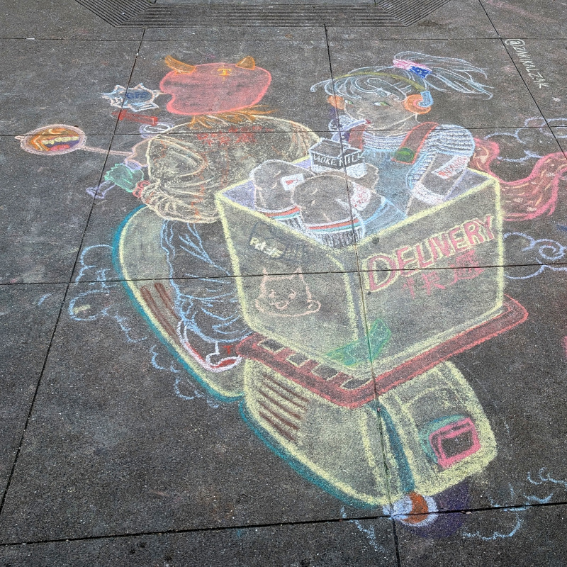 sidewalk chalk art: zooming in on the delivery scooter. a passenger in the back drinks from a carton of 'woke milk'