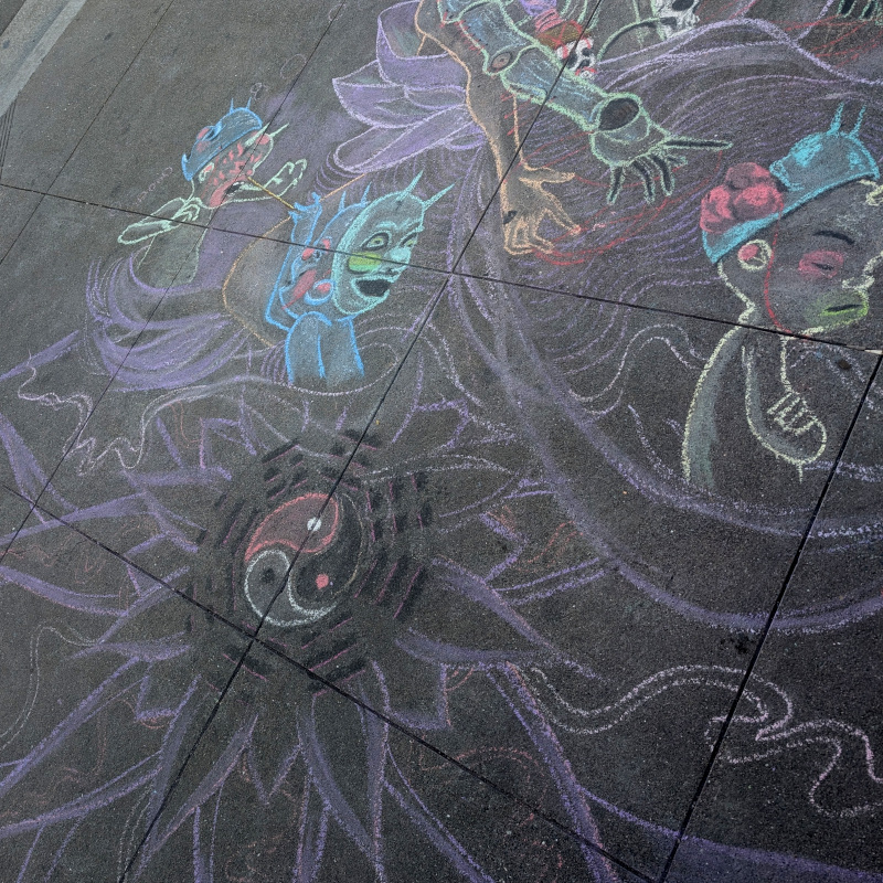sidewalk chalk art: bagua surrounding a triple yin-yang.